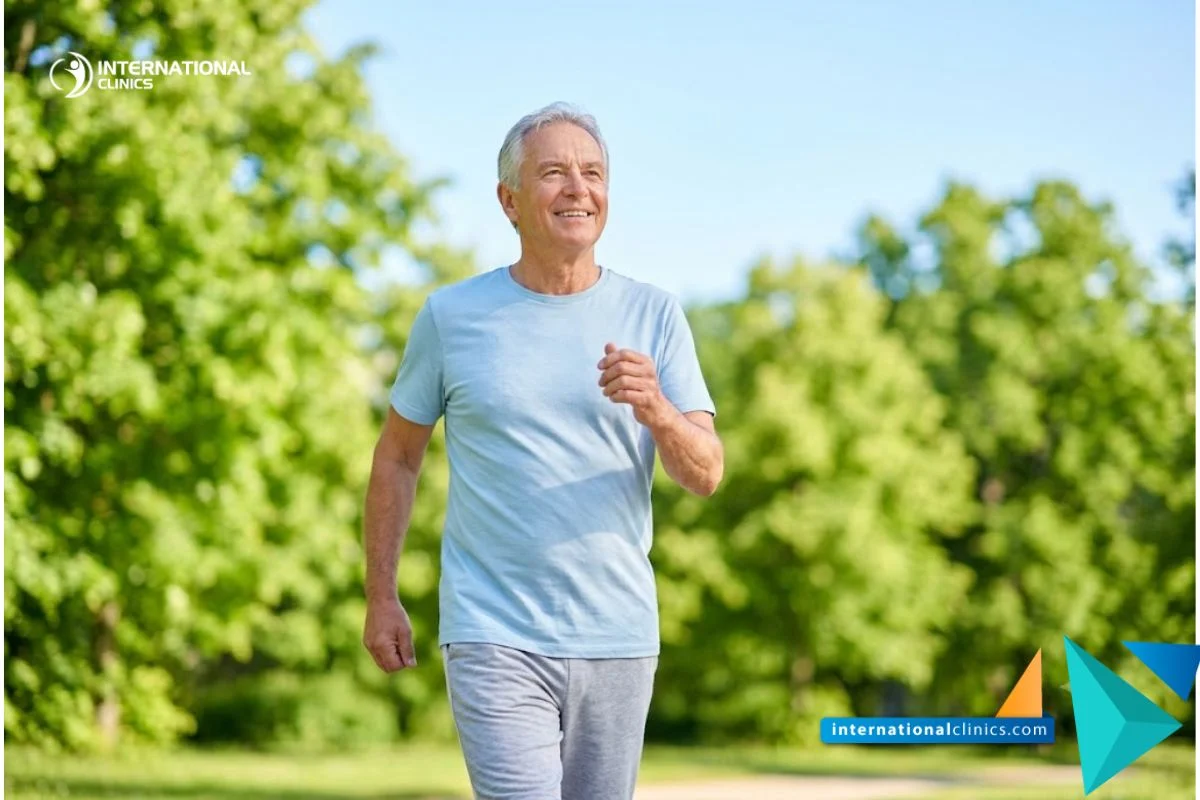 A lifestyle photograph of a smiling, active older adult breathing easily while walking in a sunny park, showing successful recovery from Advanced Emphysema, filling the canvas entirely without margins.