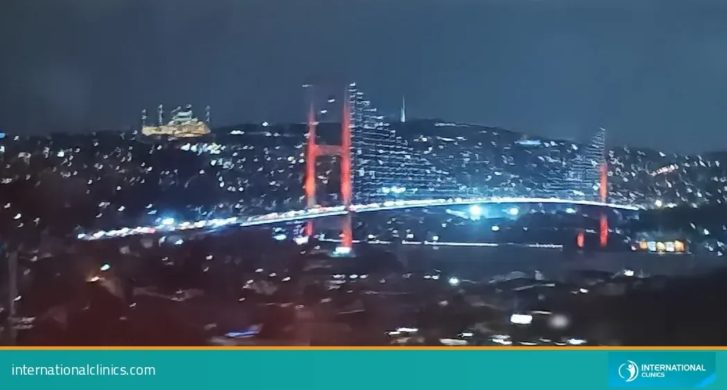 Bosphorus Bridge lit up at night over Istanbul, where many patients stay during the first days of recovery